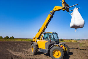 Telehandler lifting a large bag