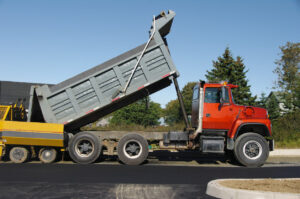 Dump truck unloading materials on site
