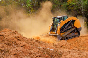 Skid steer moving dirt and dust Red Wood Dust Skid Steer