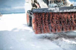 Skid steer with large broom attachment
