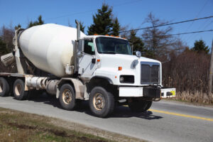 White concrete mixer truck on road