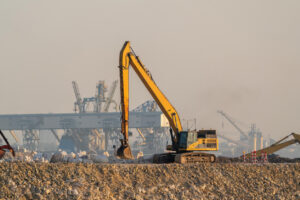 Yellow Long Reach Excavator in Smog