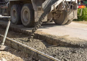 Concrete trucks pouring fresh cement