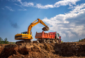 Construction equipment Excavator loading dirt into dump truck