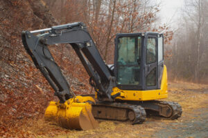 yellow mini excavator in fog